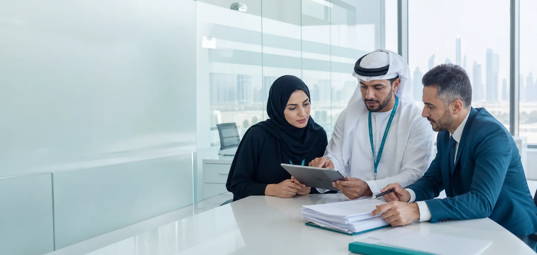Healthcare administration team reviewing controlled operational documents in a Dubai office