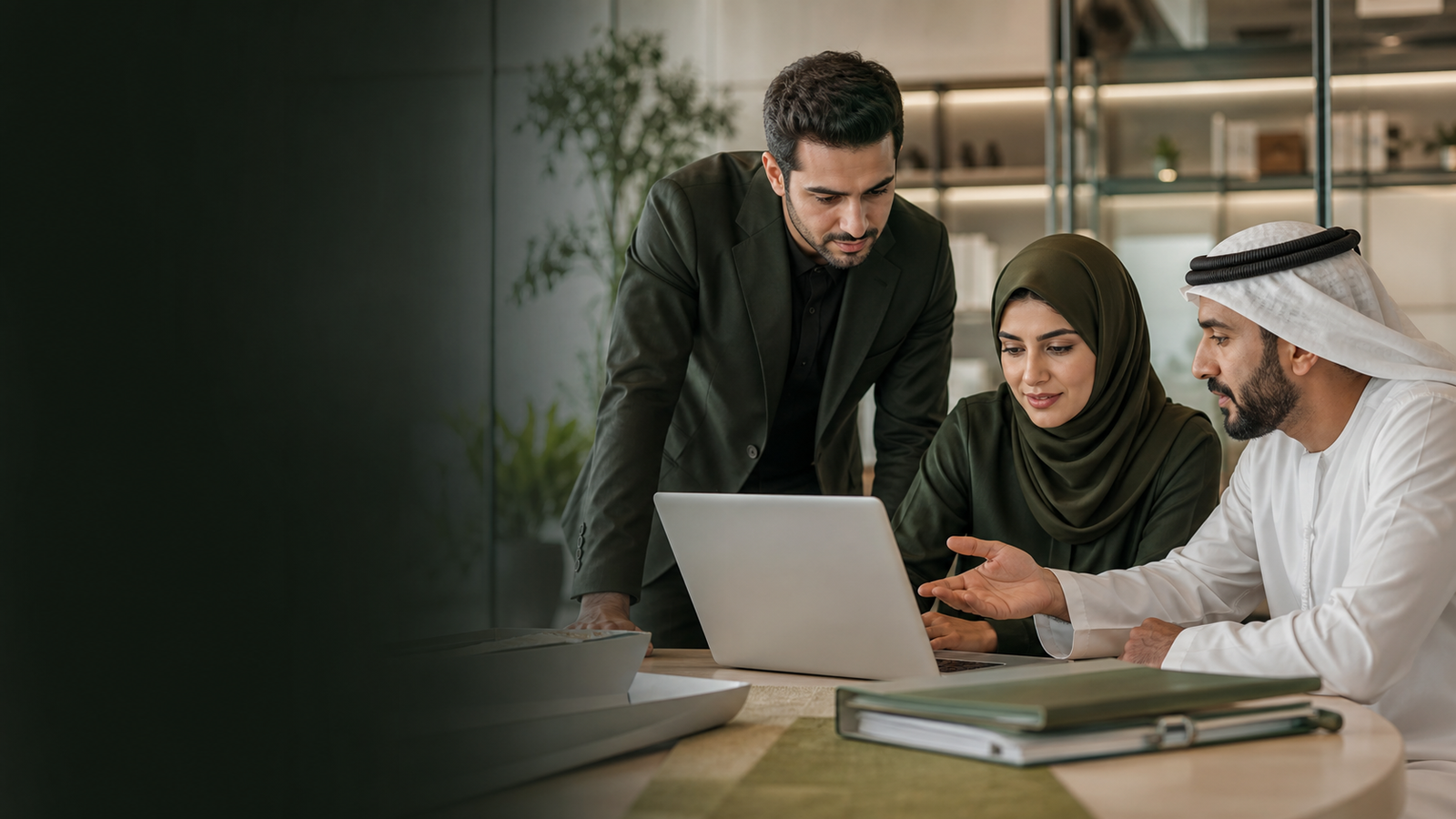 Business team reviewing documents and a laptop together in an office